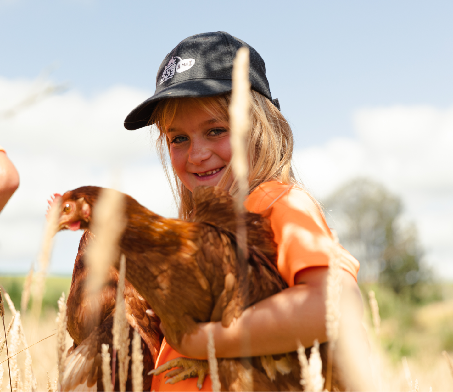 A child holding a hen